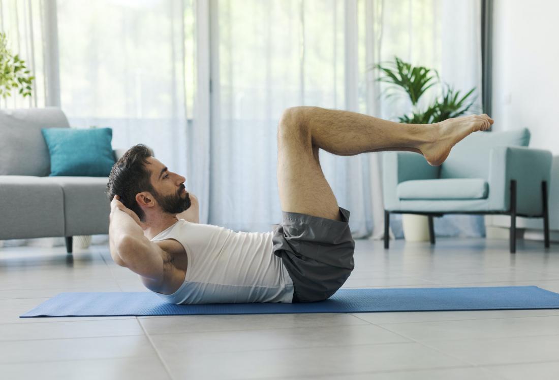 Man exercising abs at home
